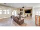 Inviting living room with wood floors, fireplace, ceiling fan, and large windows at 8490 Via De Bellasidra Ct, Las Vegas, NV 89123