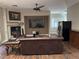 Living room with fireplace, large screen TV and hardwood floors at 8490 Via De Bellasidra Ct, Las Vegas, NV 89123