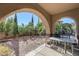 Covered patio with outdoor seating, perfect for relaxing and enjoying the backyard at 8490 Via De Bellasidra Ct, Las Vegas, NV 89123