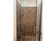 Walk-in shower with glass enclosure and brown tile at 8490 Via De Bellasidra Ct, Las Vegas, NV 89123