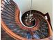 Elegant spiral staircase with ornate railing and chandelier at 8490 Via De Bellasidra Ct, Las Vegas, NV 89123