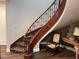 Elegant curved staircase with wood railing and patterned carpet at 8490 Via De Bellasidra Ct, Las Vegas, NV 89123