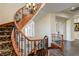 Elegant curved staircase featuring wood railing, iron spindles, and decorative carpet runner at 8490 Via De Bellasidra Ct, Las Vegas, NV 89123