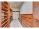 Custom walk-in closet with built-in storage shelves and drawers on both sides at 8490 Via De Bellasidra Ct, Las Vegas, NV 89123