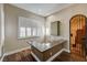 Cozy wet bar area featuring a granite countertop, shutters, and wrought iron access door at 8490 Via De Bellasidra Ct, Las Vegas, NV 89123