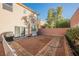 Backyard with brick and gravel patios, and a white fence at 8543 Alpine Vineyards Ct, Las Vegas, NV 89139