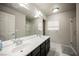 Elegant bathroom with double sinks, dark cabinets, and a shower at 8543 Alpine Vineyards Ct, Las Vegas, NV 89139