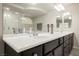 Modern bathroom with double sinks, marble countertops, and a walk-in shower at 8543 Alpine Vineyards Ct, Las Vegas, NV 89139