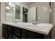 Double vanity bathroom with dark brown cabinets and marble countertop at 8543 Alpine Vineyards Ct, Las Vegas, NV 89139