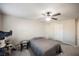 Serene bedroom with ceiling fan, cat tree, and ample natural light at 8543 Alpine Vineyards Ct, Las Vegas, NV 89139