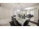 Elegant dining room with glass table, gray chairs, and chandelier at 8543 Alpine Vineyards Ct, Las Vegas, NV 89139