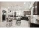 Modern kitchen featuring dark cabinetry, granite counters, and a large island at 8543 Alpine Vineyards Ct, Las Vegas, NV 89139