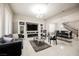 Open living room showcasing a gray sofa and entertainment center, with views into dining area at 8543 Alpine Vineyards Ct, Las Vegas, NV 89139