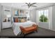 Secondary bedroom with a king-size bed and orange bench at 9656 Biedler Ct # Lot 7, Las Vegas, NV 89178