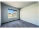 Well-lit bedroom with a window and grey carpeting at 10009 Hemet Dr, Las Vegas, NV 89134