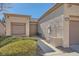 Front view of house with walkway, landscaping, and two-car garage at 10009 Hemet Dr, Las Vegas, NV 89134