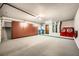 Spacious garage with wall-to-wall storage, laundry units, utility sink, and well-lit with clean epoxy floor at 10009 Hemet Dr, Las Vegas, NV 89134