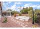 Landscaped backyard with patio, pergola, and fire pit at 10134 Donald Weese Ct, Las Vegas, NV 89129