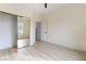 Well-lit bedroom featuring mirrored closet and wood-look floors at 10134 Donald Weese Ct, Las Vegas, NV 89129