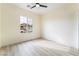 Bright bedroom with wood-look floors and a window with backyard view at 10134 Donald Weese Ct, Las Vegas, NV 89129