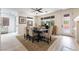 Dining area features a wooden table, neutral chairs, and access to the backyard at 10134 Donald Weese Ct, Las Vegas, NV 89129