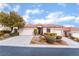 Two-story house with tile roof, landscaping, and a two-car garage at 10134 Donald Weese Ct, Las Vegas, NV 89129