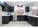 Modern kitchen with dark cabinetry and island at 10134 Donald Weese Ct, Las Vegas, NV 89129