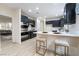 Modern kitchen with dark cabinetry and island at 10134 Donald Weese Ct, Las Vegas, NV 89129