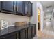 Laundry room with dark cabinets, gold handles, and wood-look floors at 10134 Donald Weese Ct, Las Vegas, NV 89129