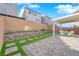 Landscaped backyard with covered patio and seating area at 10375 Rose Palisade St, Las Vegas, NV 89141