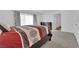 Comfortable bedroom with red and grey bedding and dresser at 10375 Rose Palisade St, Las Vegas, NV 89141