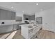 Modern kitchen with gray cabinets, white countertops, and island at 10375 Rose Palisade St, Las Vegas, NV 89141