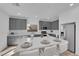 Modern kitchen with gray cabinets, white countertops, and an island at 10375 Rose Palisade St, Las Vegas, NV 89141