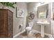 Powder room with pedestal sink and wood-look flooring at 10414 Hemingway Ct, Las Vegas, NV 89149