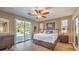 Bright bedroom with wood flooring and sliding glass doors to backyard at 10414 Hemingway Ct, Las Vegas, NV 89149