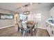 Bright dining room with a rustic wooden table and six chairs at 10414 Hemingway Ct, Las Vegas, NV 89149