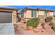 Single-story home with two-car garage and landscaped yard at 10414 Hemingway Ct, Las Vegas, NV 89149