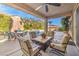 Covered patio with fire pit and comfortable seating at 10414 Hemingway Ct, Las Vegas, NV 89149