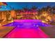 Inviting pool with a waterfall feature and colorful LED lighting at 10414 Hemingway Ct, Las Vegas, NV 89149