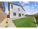 Artificial turf backyard with paver patio and view of house exterior at 1070 Kelly Brook Ln, Henderson, NV 89011