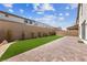 Landscaped backyard with artificial turf and paver patio at 1070 Kelly Brook Ln, Henderson, NV 89011