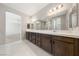 Double vanity bathroom with a large mirror and walk-in shower at 1070 Kelly Brook Ln, Henderson, NV 89011