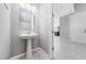 Clean and contemporary powder room with pedestal sink at 1070 Kelly Brook Ln, Henderson, NV 89011