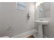 Small bathroom with pedestal sink and gray walls at 1070 Kelly Brook Ln, Henderson, NV 89011