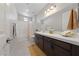 Modern bathroom with double vanity, bathtub, and shower at 1070 Kelly Brook Ln, Henderson, NV 89011