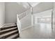 Spacious entryway with tiled floor, staircase, and view to living room at 1070 Kelly Brook Ln, Henderson, NV 89011