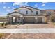 Two-story house with three-car garage, stone accents, and landscaped yard at 1070 Kelly Brook Ln, Henderson, NV 89011