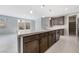 Modern kitchen with island, dark cabinets, and walk-in pantry at 1070 Kelly Brook Ln, Henderson, NV 89011