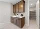 Kitchen features wood cabinets, white countertops, and walk-in pantry at 1070 Kelly Brook Ln, Henderson, NV 89011