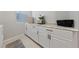 Bright laundry room with granite countertop and white cabinets at 1070 Kelly Brook Ln, Henderson, NV 89011